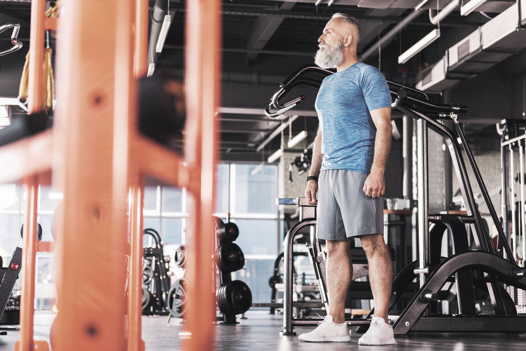 Zamyślony stary mężczyzna jest trening w siłowni - Zdjęcie, obraz