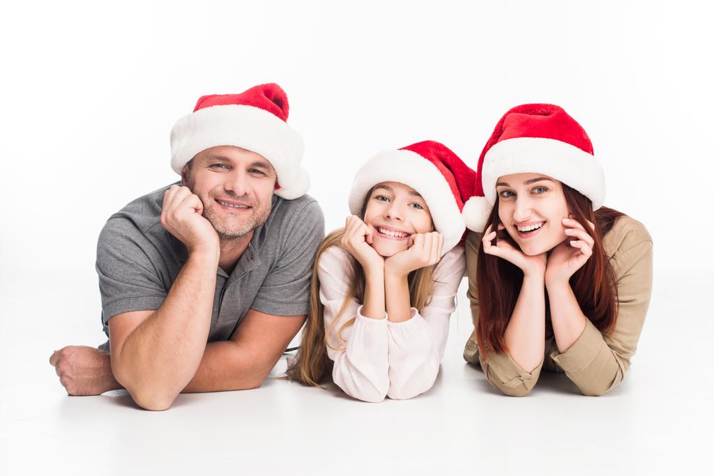 famille souriante dans des chapeaux de Père Noël
   - Photo, image