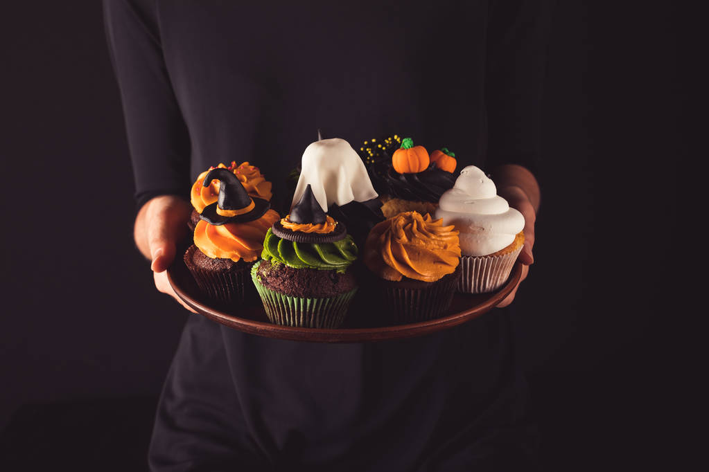 person holding halloween cupcakes  - Photo, Image