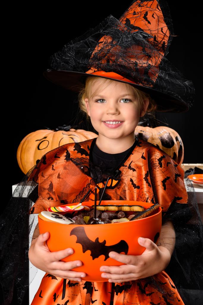 Kleine Hexe mit Halloween-Süßigkeiten - Foto, Bild