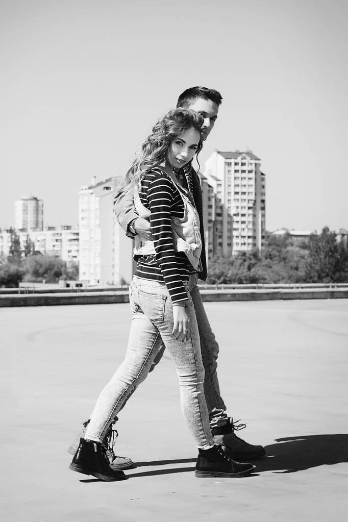 Young beautiful fashion couple wearing jeans clothes in daylight - Photo, Image