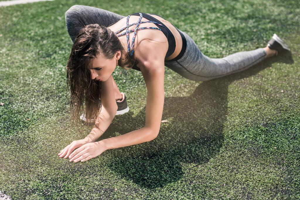 woman stretching on sports field - Photo, Image