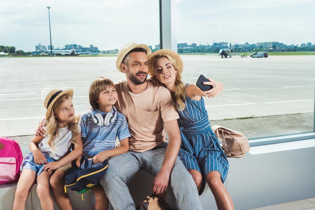 happy family taking selfie in airport - Photo, Image