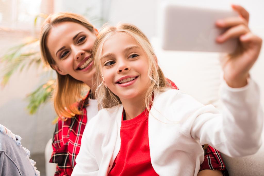 mother and daughter taking selfie - Photo, Image