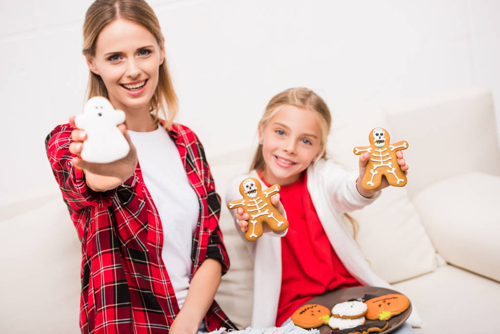 mother and daughter with halloween cookies - Photo, Image