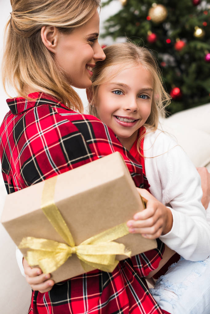 mother and daughter with christmas present - Photo, Image