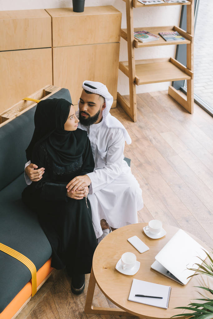 muslim couple embracing on couch - Photo, Image