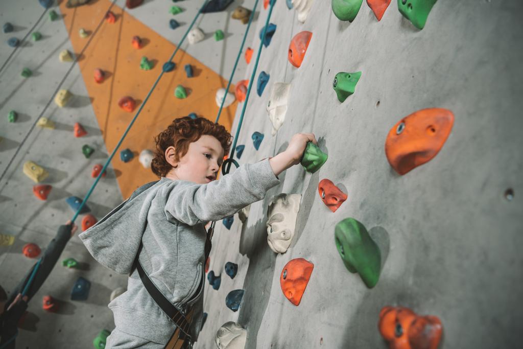 Little boy climbing wall at gym - Photo, Image