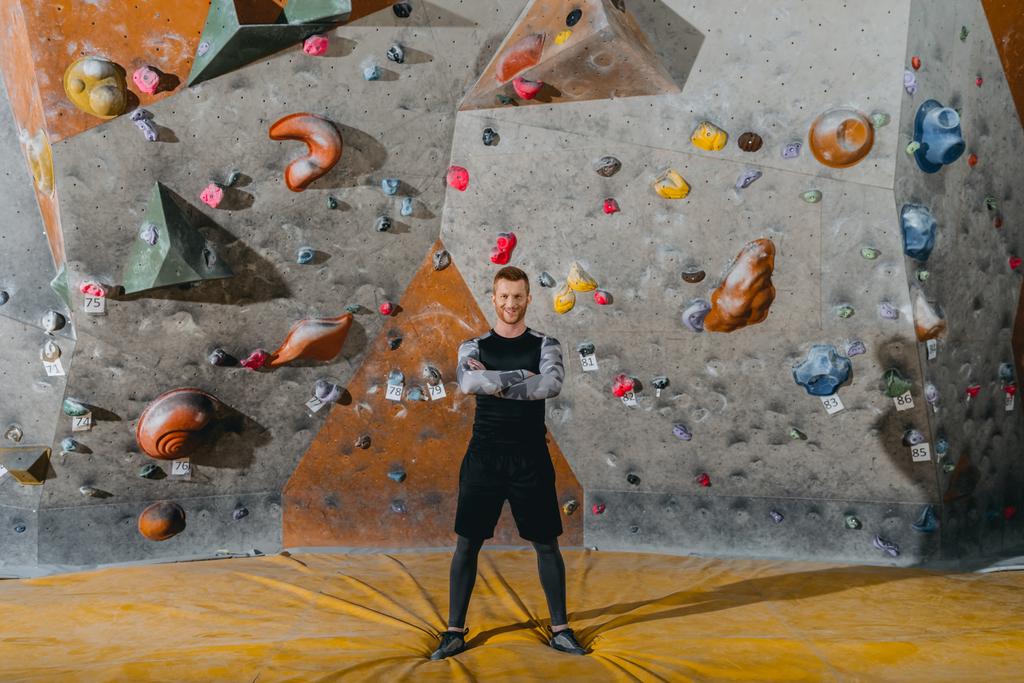 young man in front of climbing wall - Photo, Image