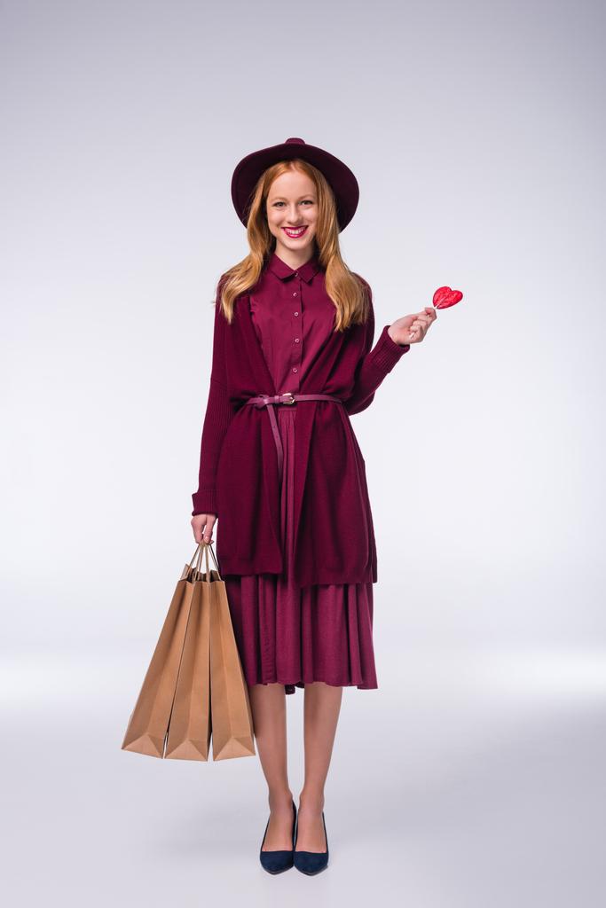 girl with shopping bags and lollipop - Photo, Image
