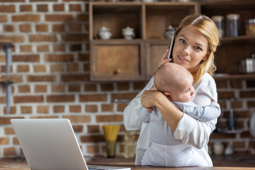 businesswoman with baby in hands - Photo, Image