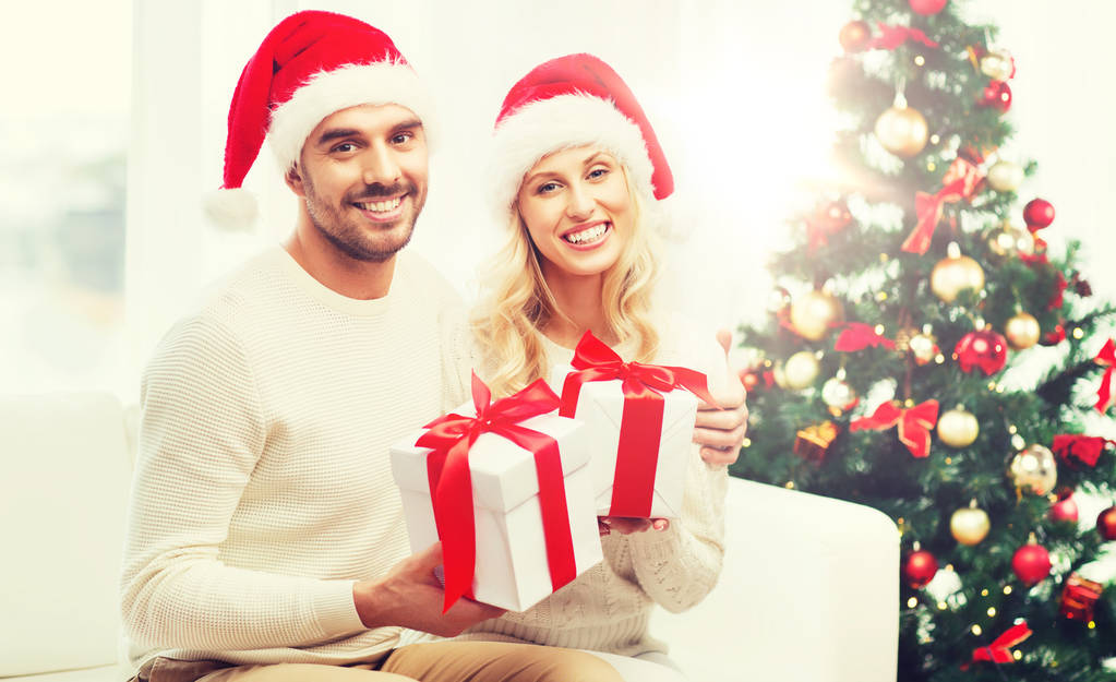 felice coppia a casa con scatole regalo di Natale
 - Foto, immagini
