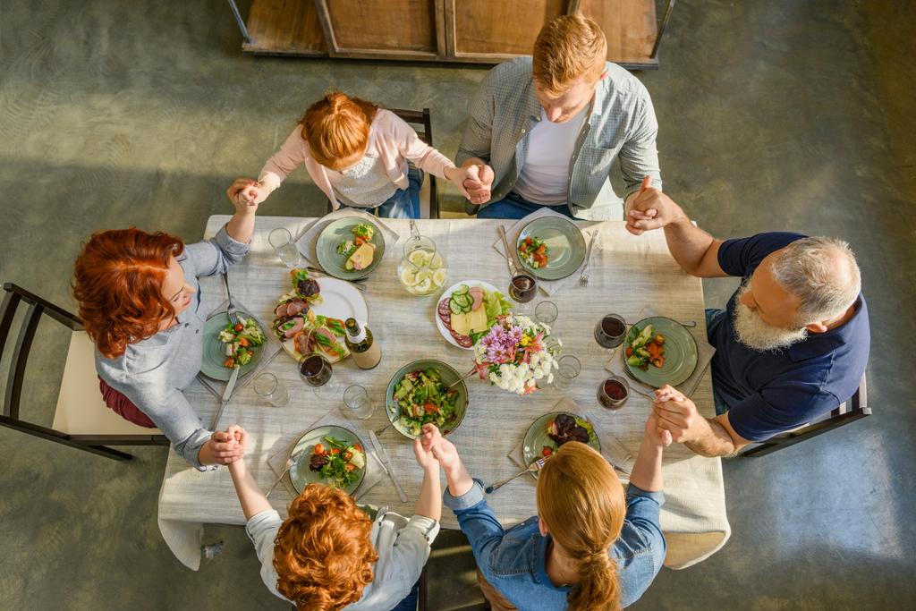 Familie betet beim Abendessen - Foto, Bild