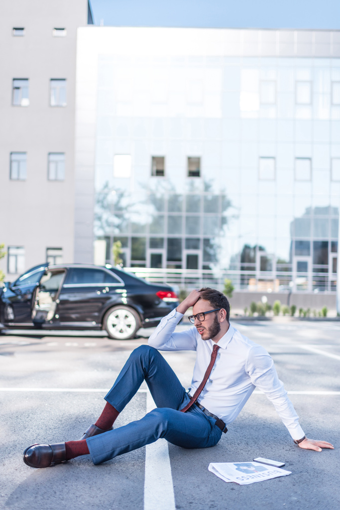 homem de negócios estressado sentado no estacionamento
 - Foto, Imagem