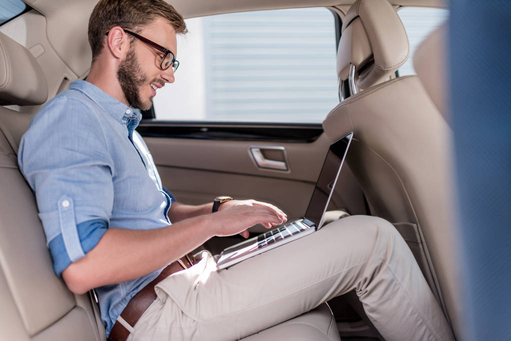 man using laptop in car - Photo, Image