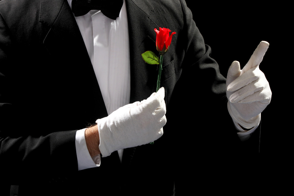 Young magician performing red rose - Photo, Image