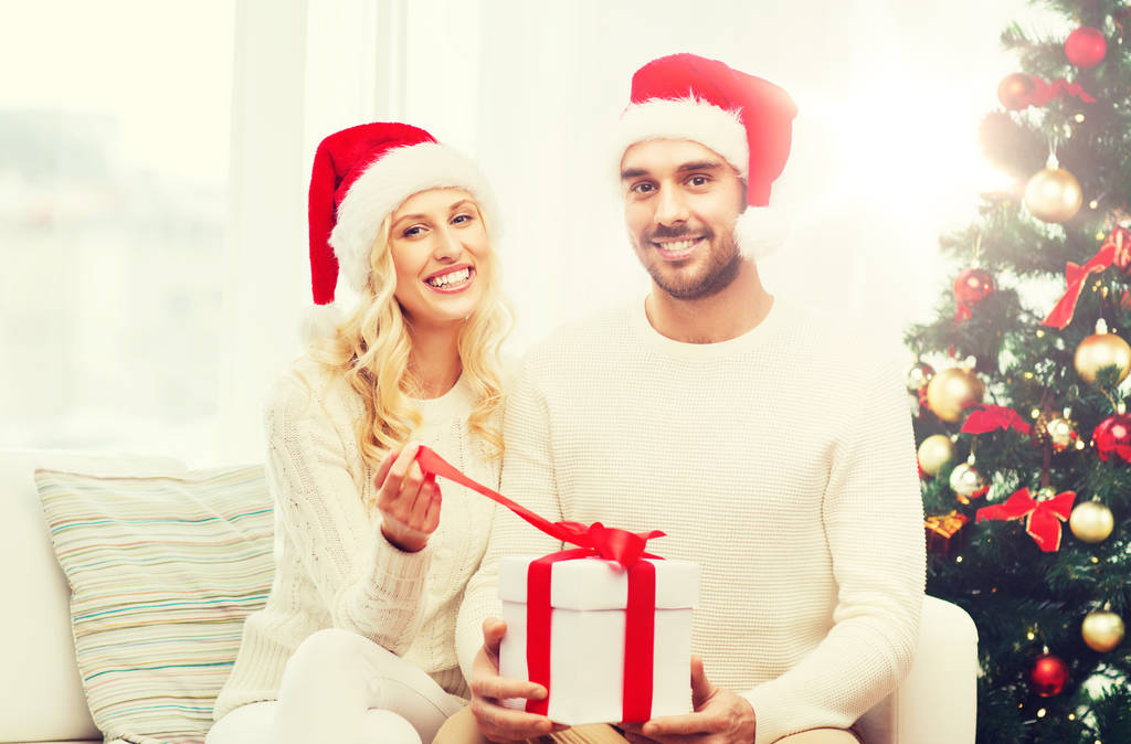 feliz pareja en casa con caja de regalo de Navidad
 - Foto, Imagen