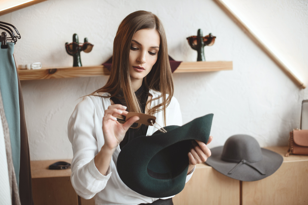 woman with hat in boutique - Photo, Image