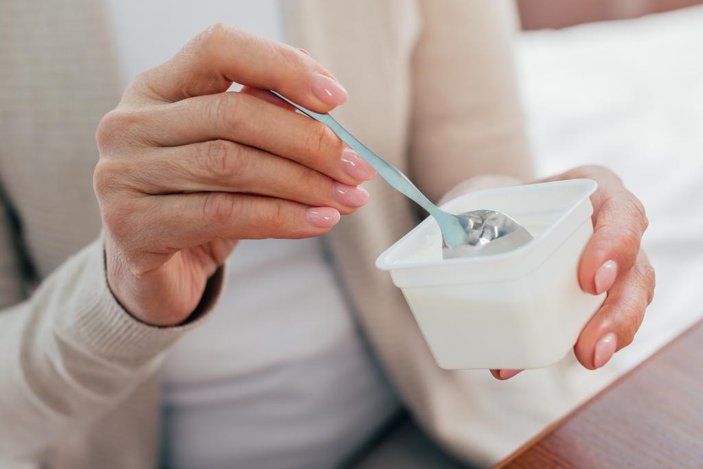 Senior mulher comendo iogurte
  - Foto, Imagem