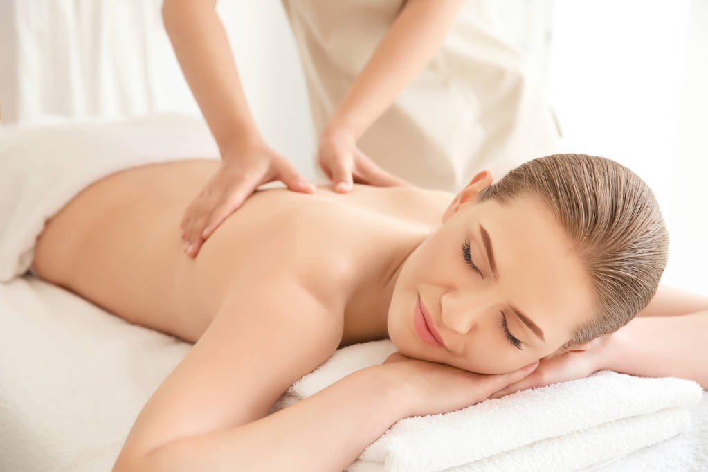 Young beautiful woman having massage in spa salon - Photo, Image