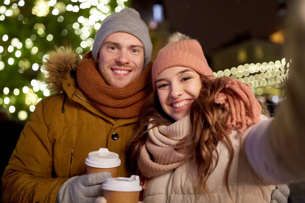 couple with coffee taking selfie at christmas - Photo, Image