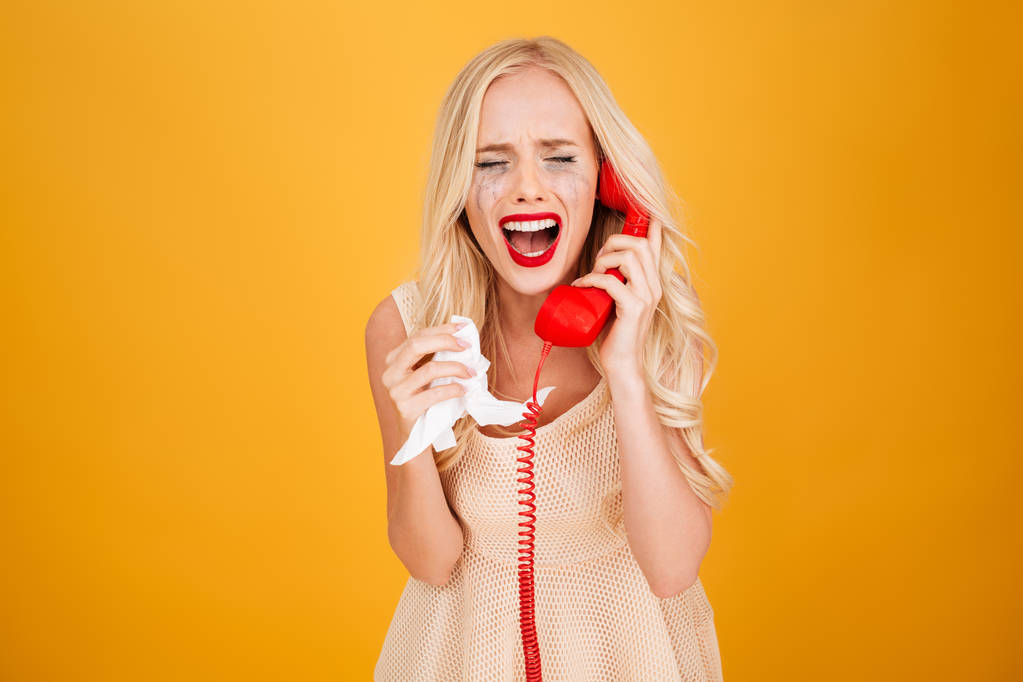 Sad crying screaming young blonde woman talking by telephone. - Photo, Image