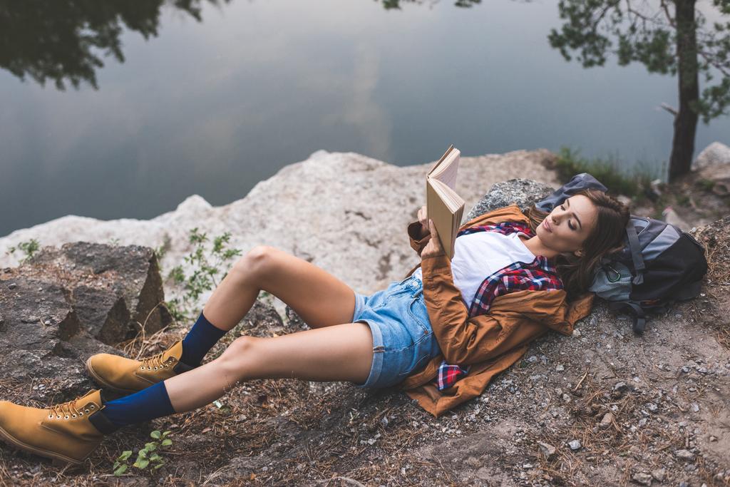 woman reading book on nature - Photo, Image