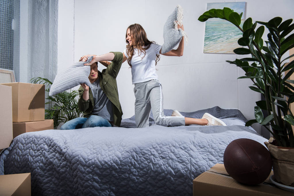 couple having pillow fight at home - Photo, Image