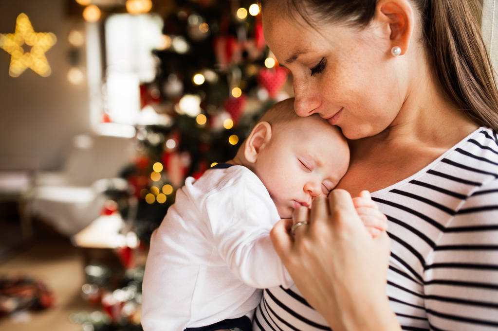 Young woman with a baby boy at Christmas time. - Photo, Image
