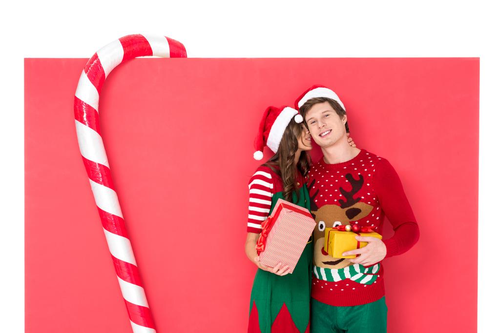 couple in santa hats with gifts - Photo, Image