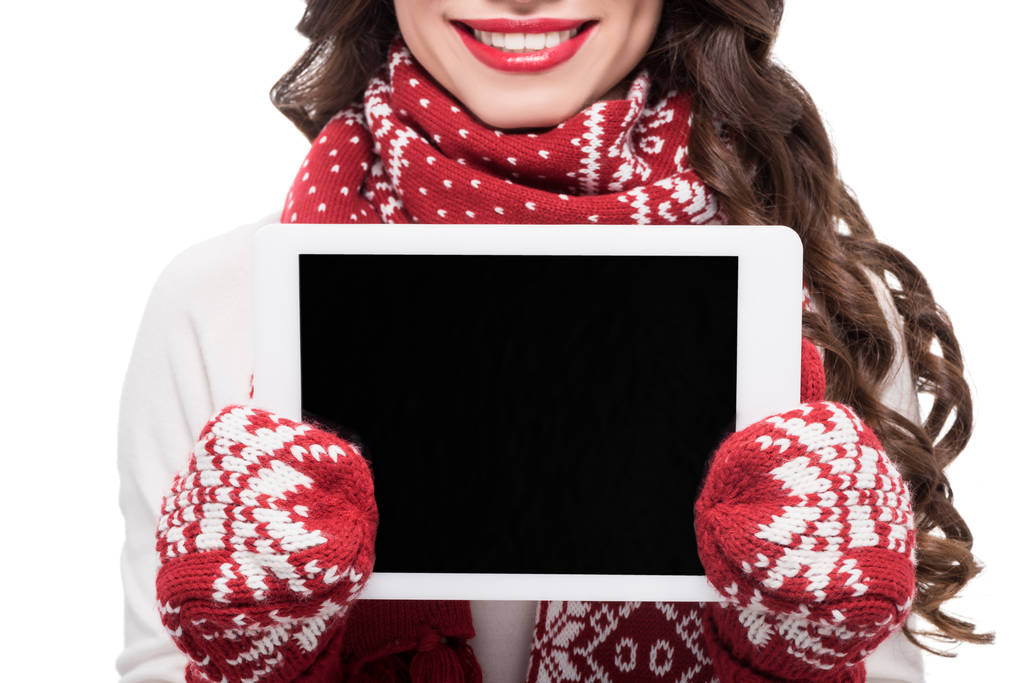 Woman in winter clothes showing tablet - Photo, Image