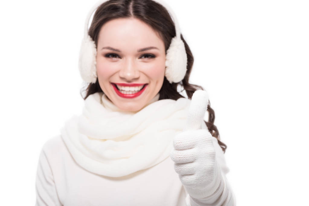 Woman in earmuffs showing thumb up - Photo, Image