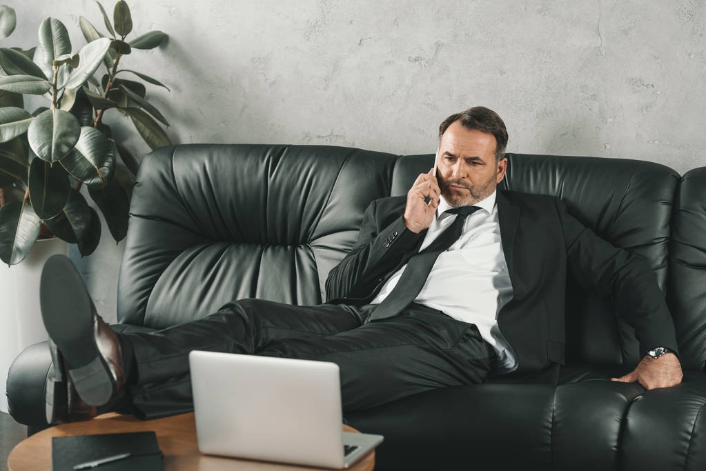businessman talking by phone on couch - Photo, Image