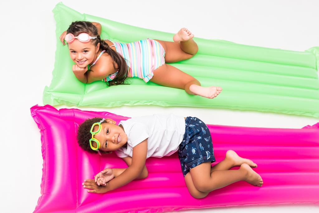 kids in swimwear on swimming mattresses   - Photo, Image