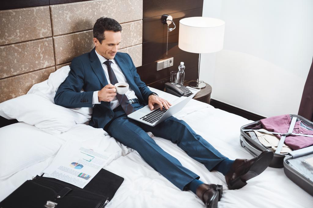 businessman on bed working with laptop - Photo, Image