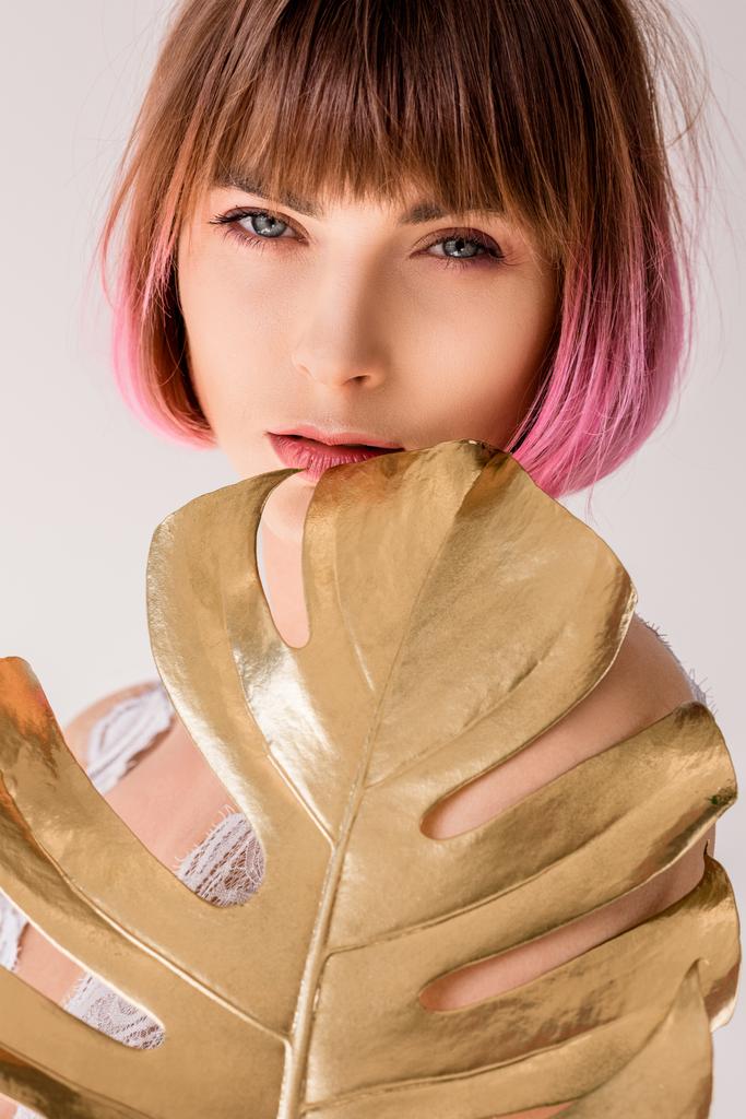 mulher posando com folha de palma dourada
  - Foto, Imagem