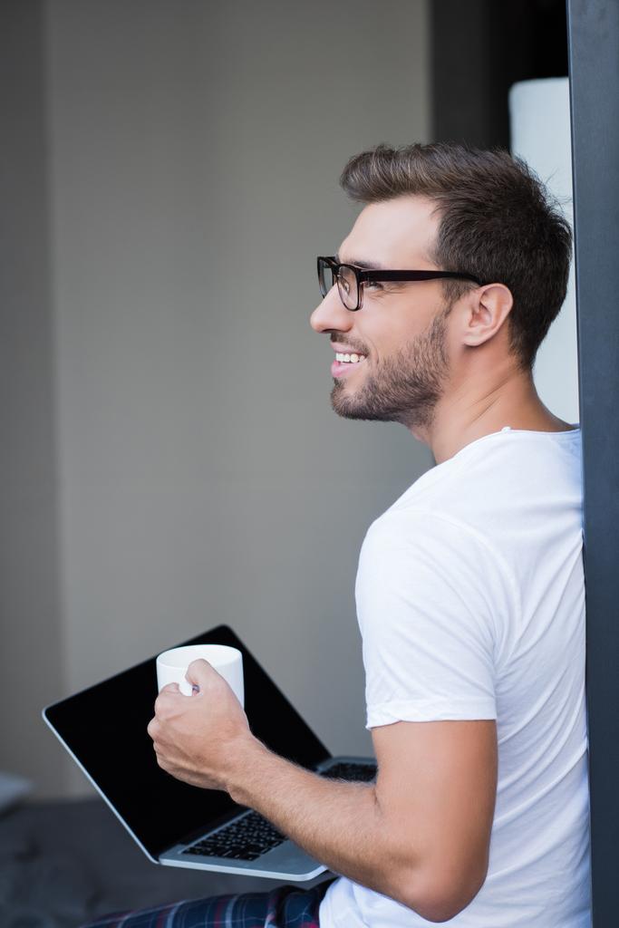 man holding laptop and coffee - Photo, Image