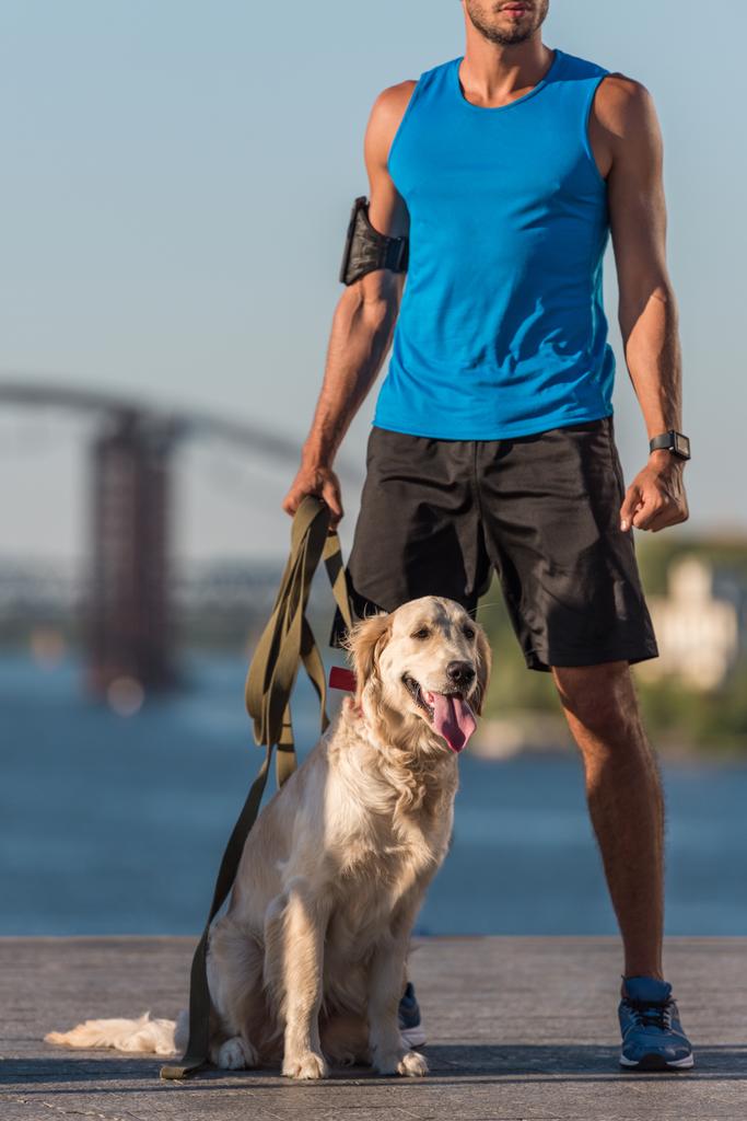 sportowca z psem na nabrzeżu - Zdjęcie, obraz