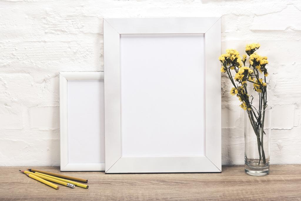 empty photo frames and flowers in vase - Photo, Image