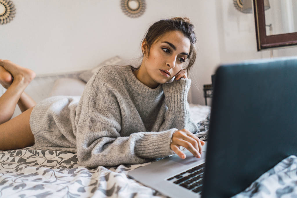 woman in bed browsing laptop - Photo, Image