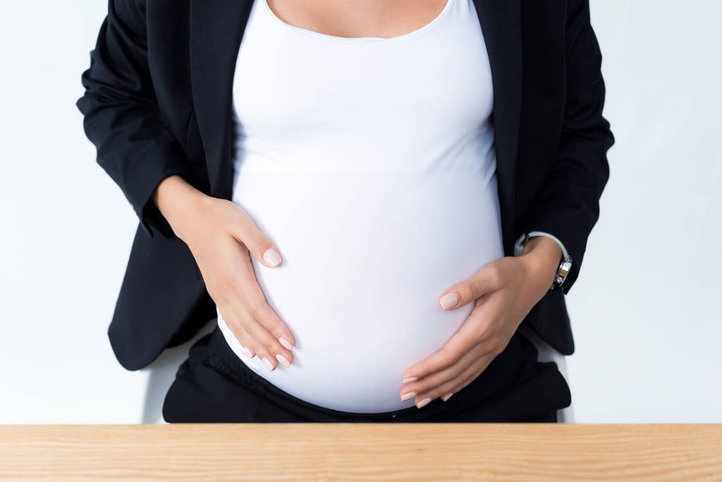 pregnant businesswoman touching her tummy - Photo, Image