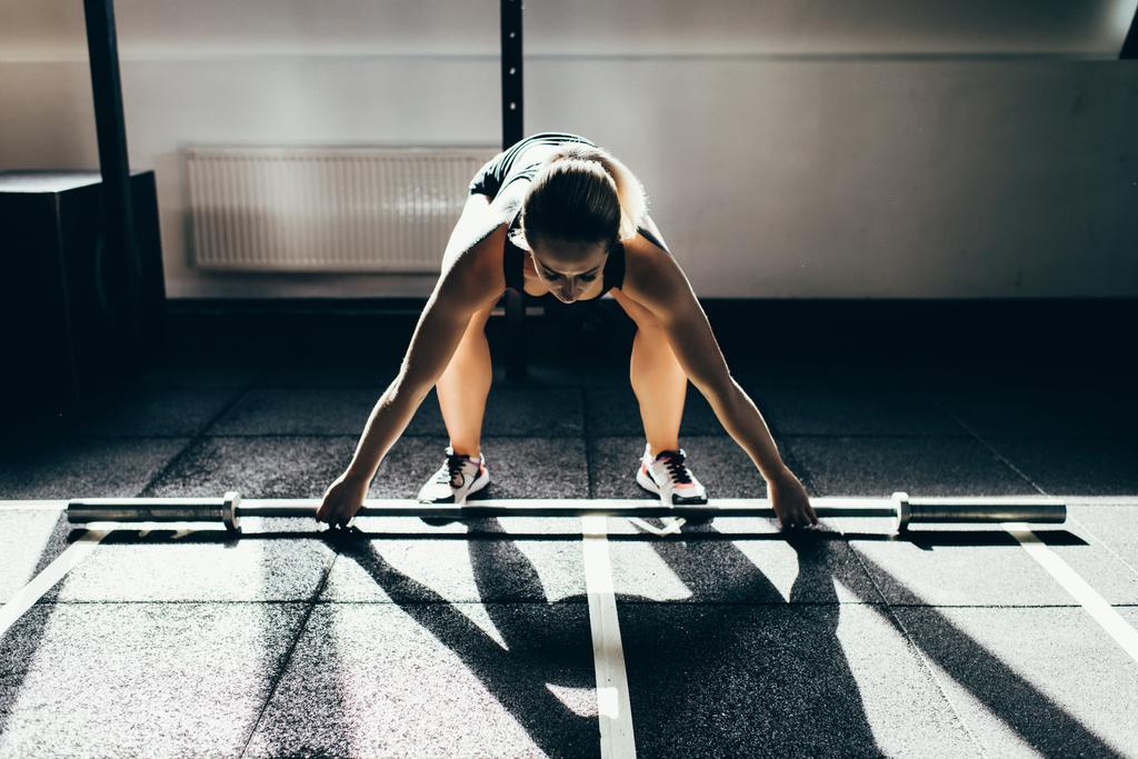 sportswoman lifting barbell  - Photo, Image
