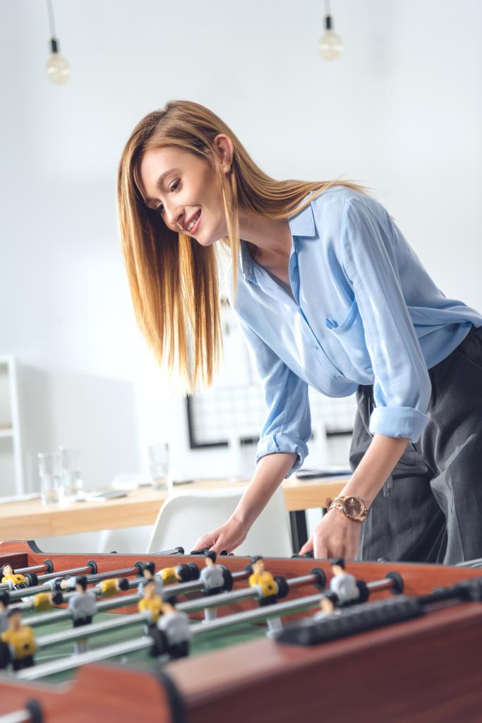 businesswoman playing table football - Photo, Image