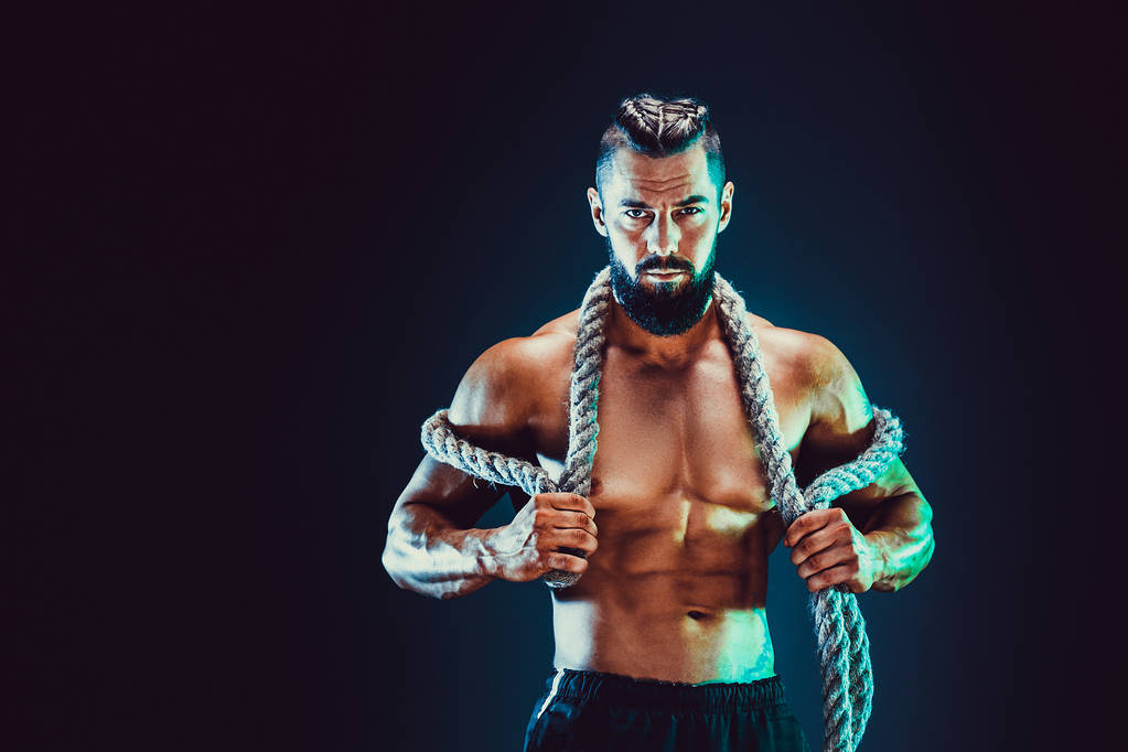 Portrait of shirtless bodybuilder. Muscular man posing in studio. - Photo, Image