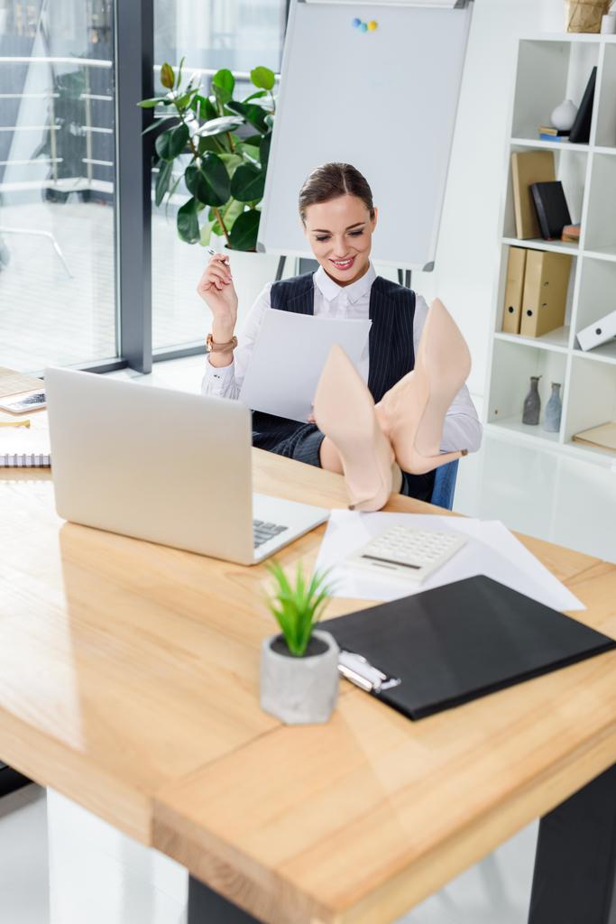 businesswoman sitting with feet on desk - Photo, Image
