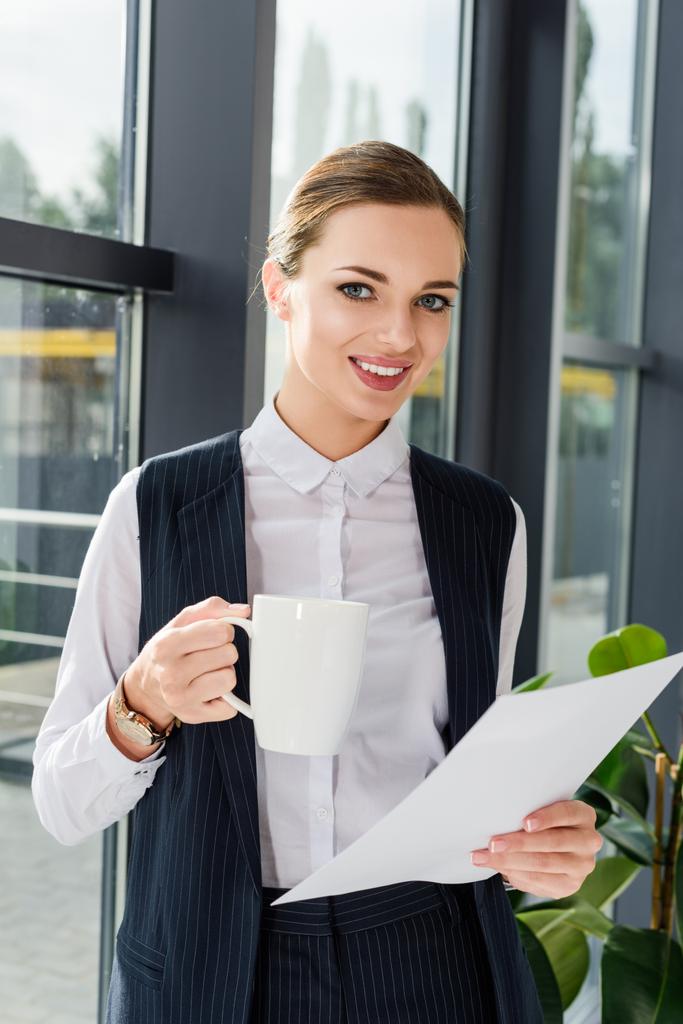 businesswoman holding cup and papers - Photo, Image