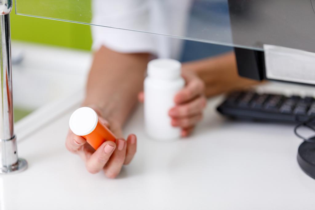 pharmacien tenant des récipients avec des médicaments
 - Photo, image