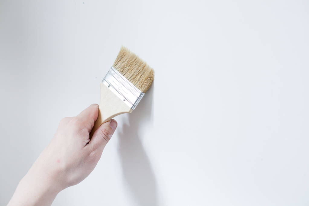 Painter painting the white wall in house - Photo, Image