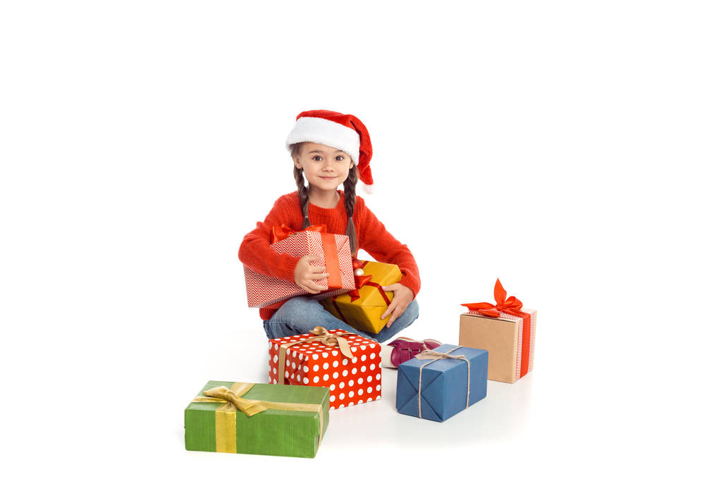 Kind mit Weihnachtsgeschenken - Foto, Bild