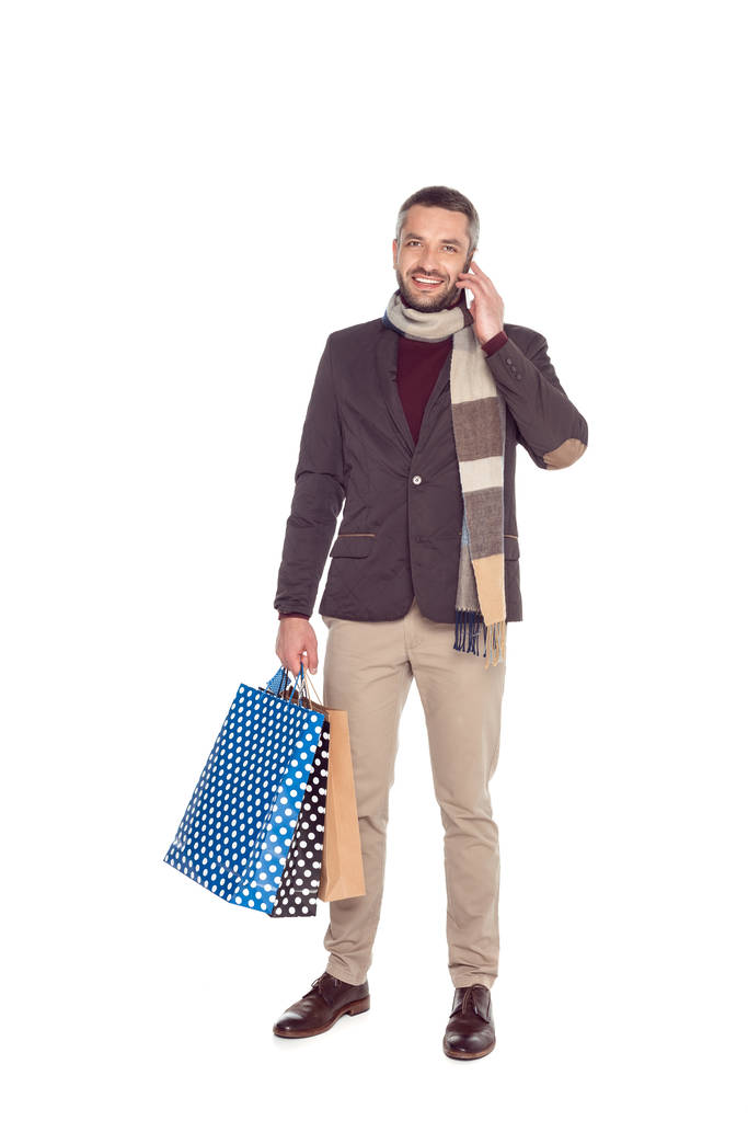 man with shopping bags and smartphone - Photo, Image